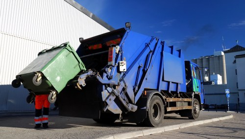 Company staff handling commercial waste bins
